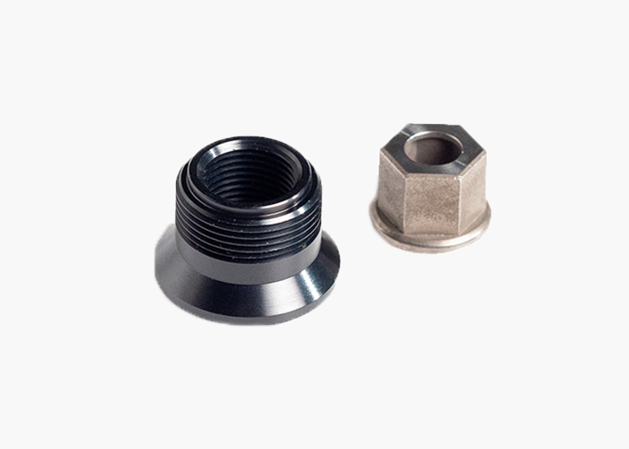Tailfin Pearson axle adaptor featuring a black threaded sleeve and silver hex nut.
