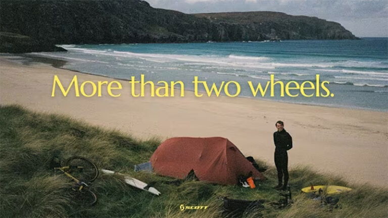 girl next to tent camping on the beach scotland