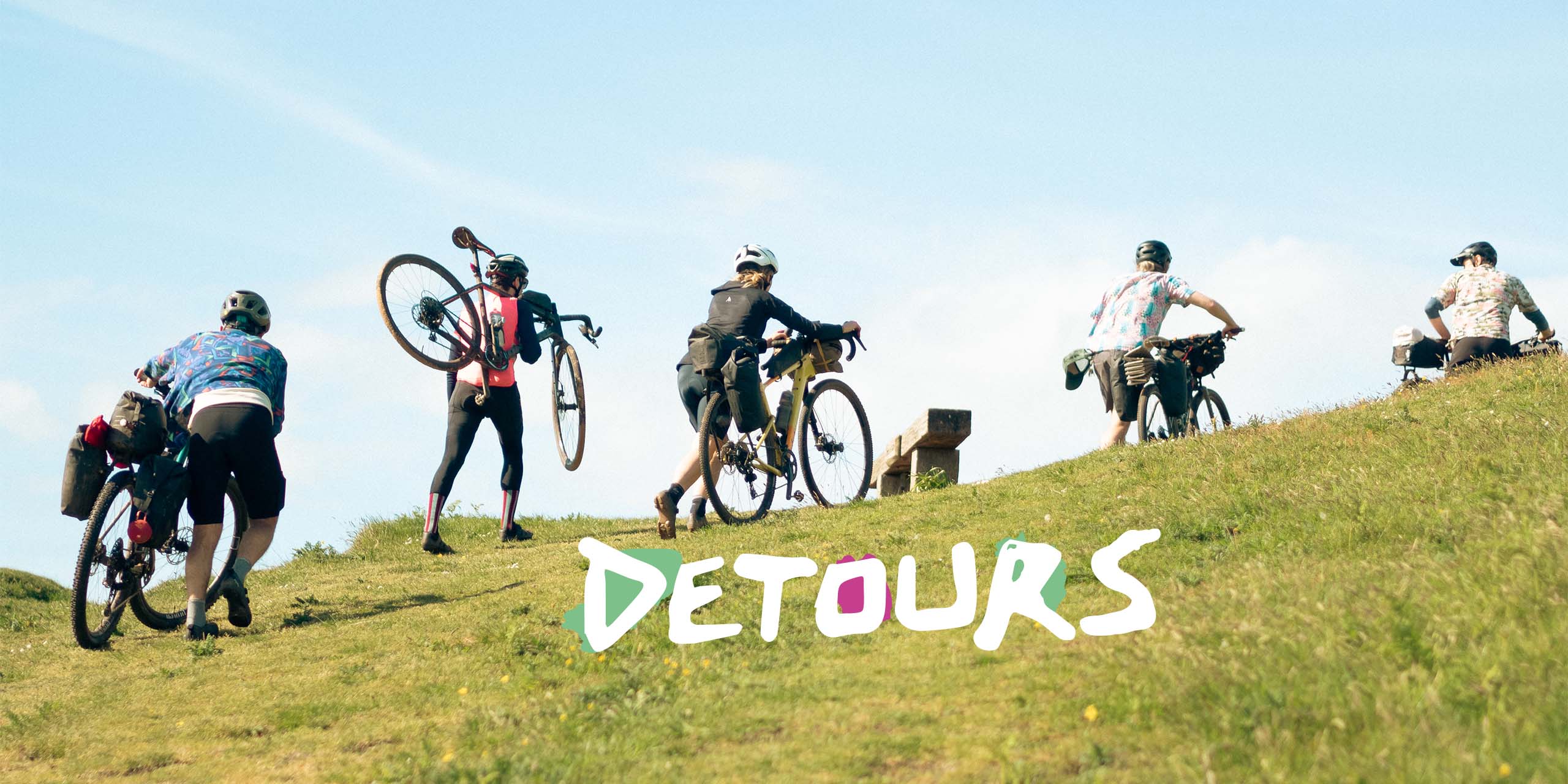 people cycling up a hill