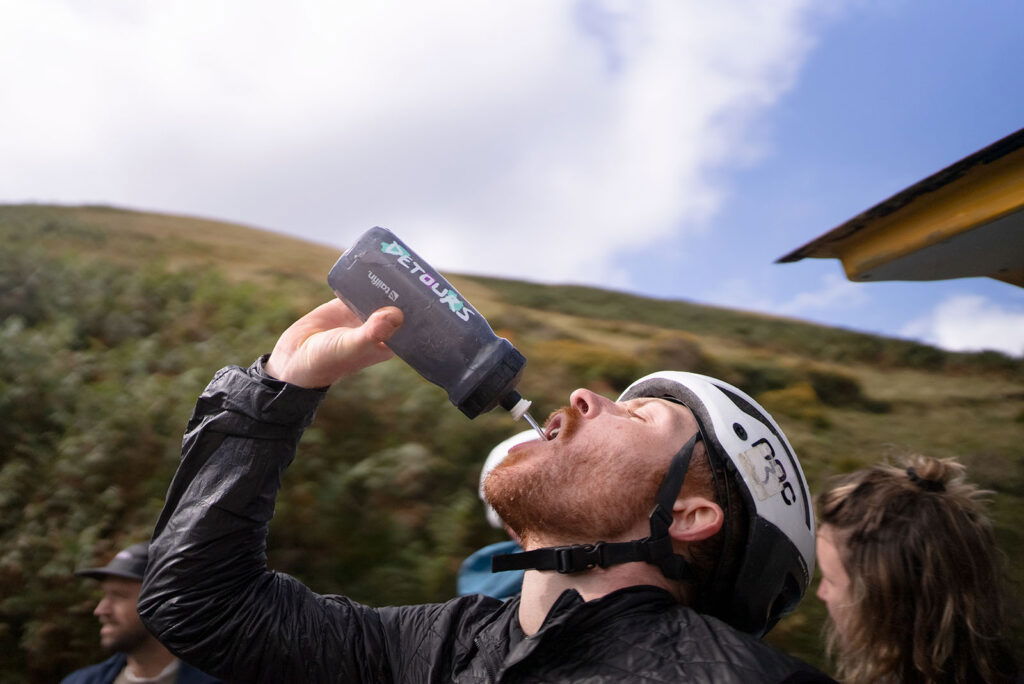 Someone drinking from a Detours bottle