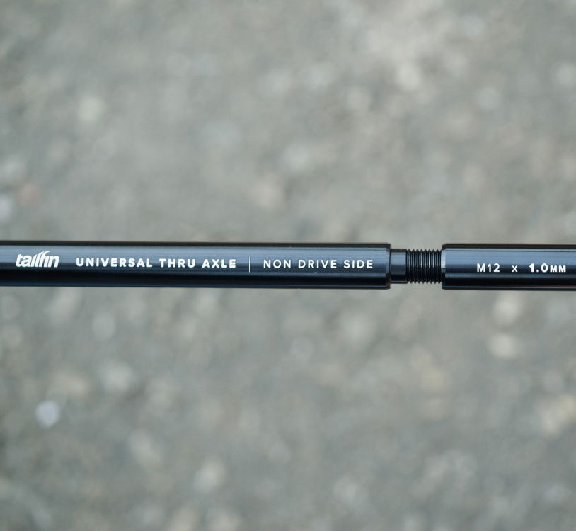 front-facing view of the tailfin Universal Thru Axle being threaded together