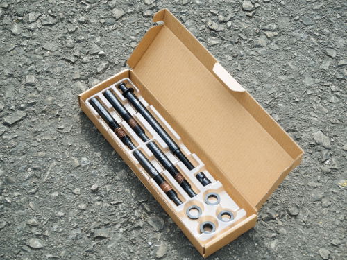 Box containing Tailfin Universal Thru Axle parts 