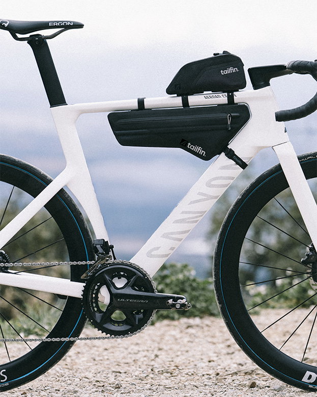Tailfin bikepacking bags fitted on a white Canyon Aeroad road bike.