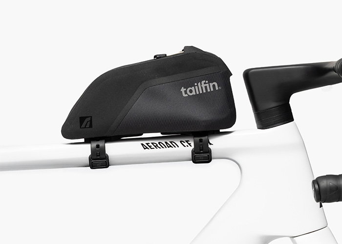 Tailfin aerodynamic top tube bag mounted on a white road bike frame.