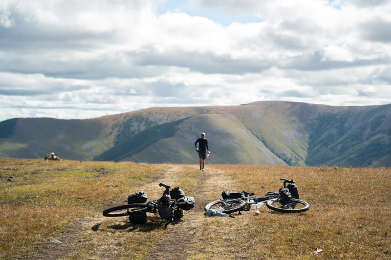 Adventure bicycles equipped with Tailfin bikepacking gear on a scenic mountain trail.