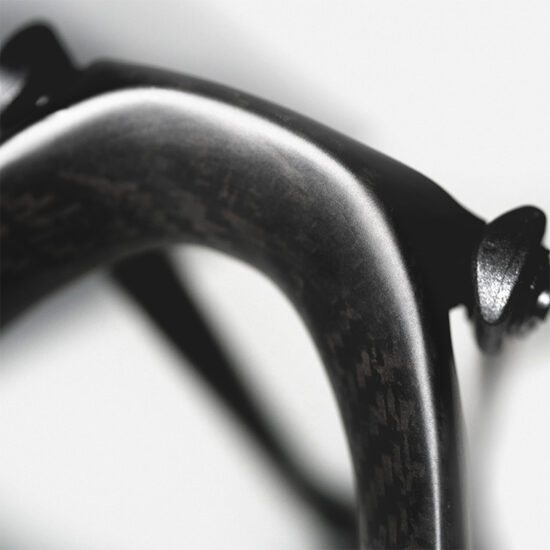 Tailfin carbon fibre bike component in a detailed black and white macro photograph.