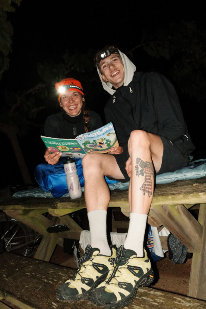 A couple enjoying a night camp during a Tailfin bikepacking adventure.