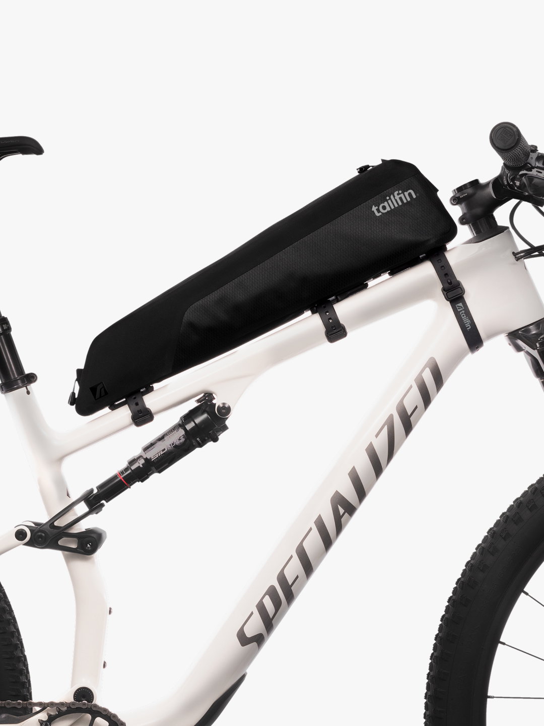 Black Tailfin top tube bag mounted on a white Specialized mountain bike.