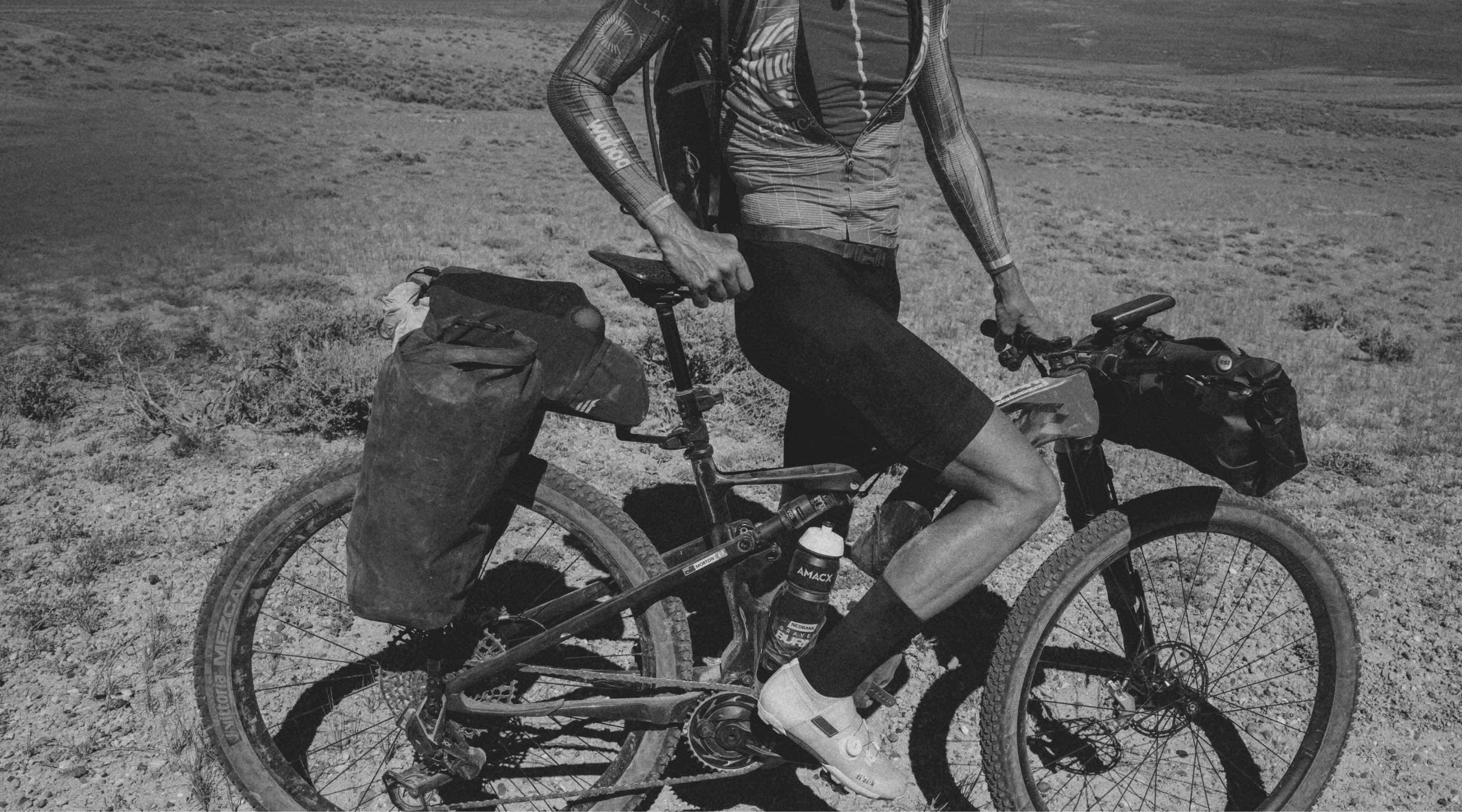 Tailfin bikepacking bags on a mountain bike in a rugged desert landscape.